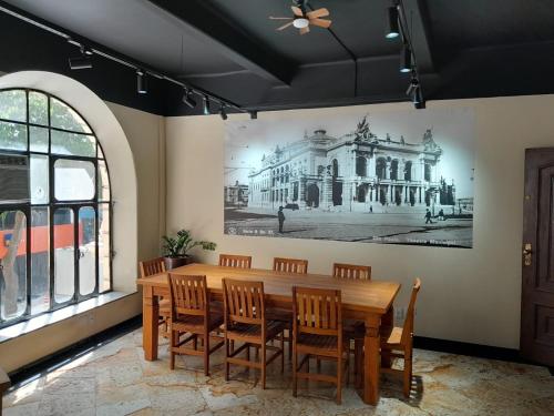 a dining room with a large painting on the wall at Excelente apto Centro SP - Tudo a pé in Sao Paulo
