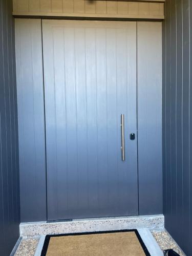 a garage door with a rug in front of it at Riverbank House in Mudgee