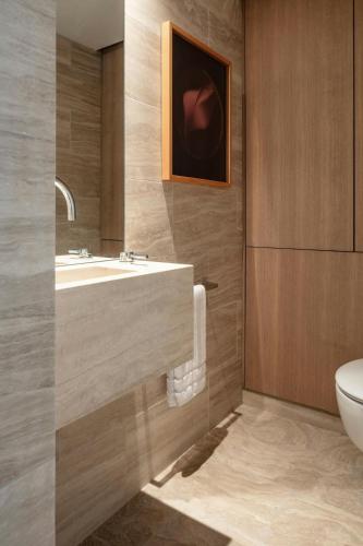 a bathroom with a sink and a toilet at The Jaffa - Fattal Limited Edition in Tel Aviv