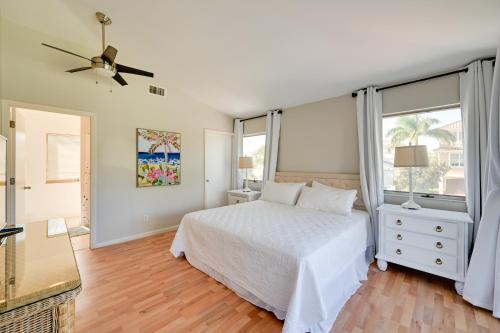 a bedroom with a white bed and a window at Sunny Marco Island Gem with Shared Pool and Dock! in Marco Island
