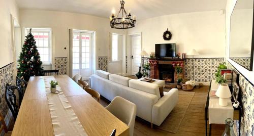 a living room with a table and a christmas tree at Historic Douro Valley Quinta in Lamego