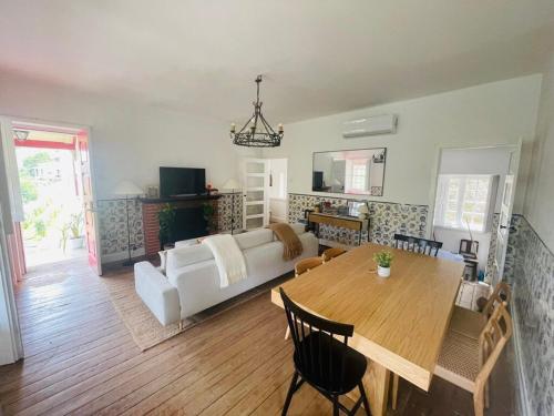 a living room with a table and a couch at Historic Douro Valley Quinta in Lamego