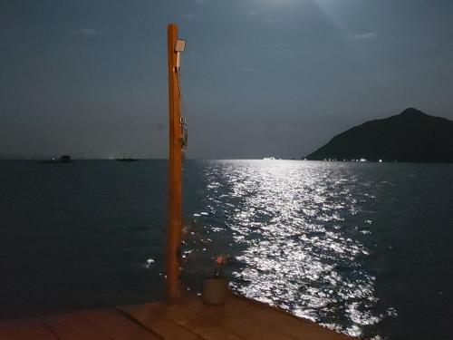 a pole in the water near the ocean at night at Villa Mangrove Pulau Pahawang in Lampung