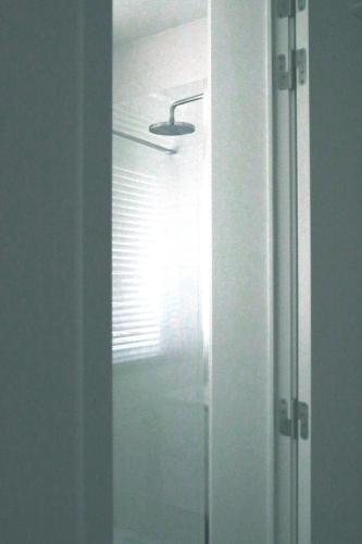 a bathroom mirror with a reflection of a window at Luxury 2 Bedroom - Antwerp City Centre in Antwerp