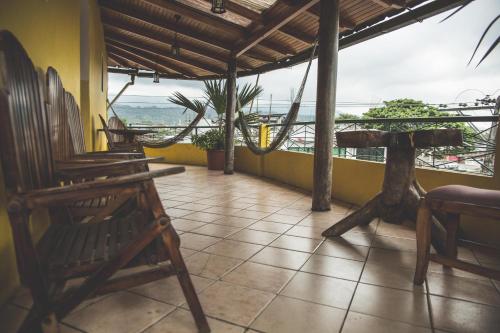 a room with chairs and a view of the ocean at Hostal Las Palmas in Puyo