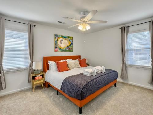 a bedroom with a bed with a ceiling fan at The Caspian large family house with private pool in Summerville in Summerville