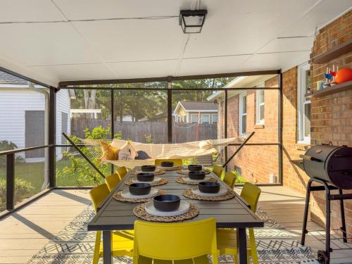 a patio with a table and chairs on a balcony at The Caspian large family house with private pool in Summerville in Summerville