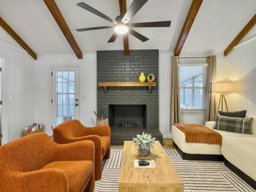 a living room with a couch and a fireplace at The Caspian large family house with private pool in Summerville in Summerville