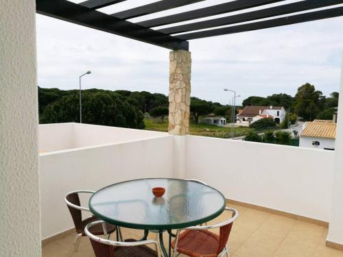 a glass table on a balcony with a view at Casa Campo e Praia by DolceStay - V4 no Meco a 5min da Praia com Jardim & BBQ in Sesimbra