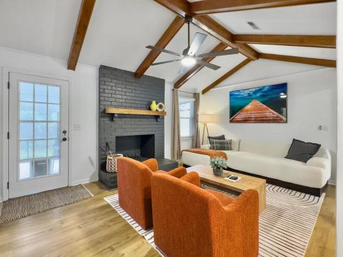 a living room with a couch and a fireplace at The Caspian large family house with private pool in Summerville in Summerville