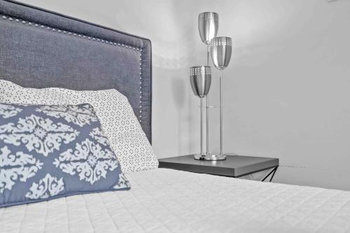 a bed with a pillow and a lamp on a nightstand at Wonderful Intracoastal Home Heated Pool EastDelray in Delray Beach