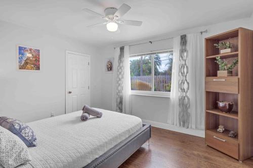 a bedroom with a bed with a teddy bear on it at Wonderful Intracoastal Home Heated Pool EastDelray in Delray Beach