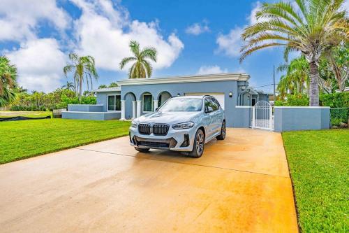a white car parked in front of a house at Wonderful Intracoastal Home Heated Pool EastDelray in Delray Beach