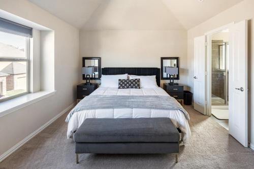 a bedroom with a large bed and a window at Bright and Spacious 3 Bedroom Townhome, Minutes from DFW Airport in Irving