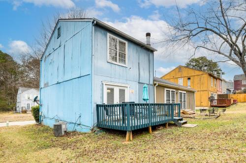 a blue house with a porch in a yard at 8 Mi to Stone Mountain Quiet Getaway with Deck in Lithonia