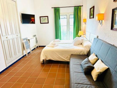 a living room with two beds and a couch at Puente del Rey, El Rocio Deluxe in El Rocío