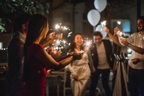 a group of people holding sparklers at a wedding at Excelsior Hotel Gallia, a Luxury Collection Hotel, Milan in Milan