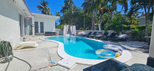 a swimming pool in the backyard of a house at Pool Paradise Half mile to Beach w Massive Yard! in Hollywood