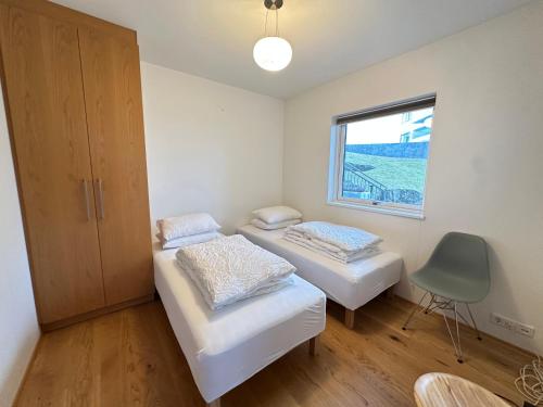a room with two beds and a window at Apartment in Austurkór- Birta Rentals in Reykjavík