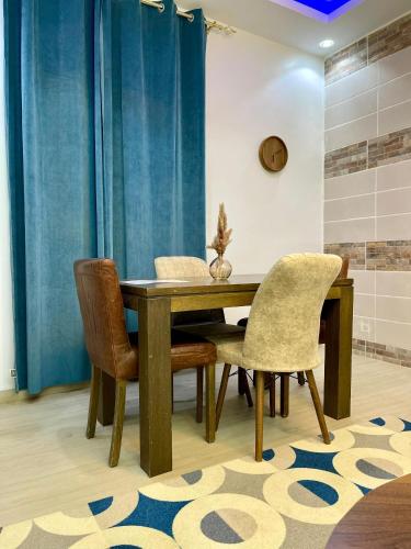 a dining room with a wooden table and chairs at Welcome Home202 Saint-Louis in Saint-Louis