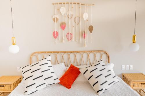 a bedroom with a bed with two pillows at Condos Privados en Huatulco in Tangolunda