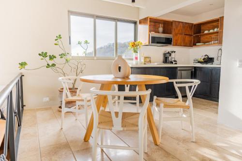 a kitchen with a wooden table and chairs at Condos Privados en Huatulco in Tangolunda