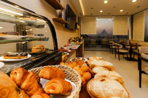 a bakery with many different types of breads and pastries at Rixoss Tower Pyramids View in Cairo