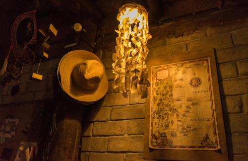 a hat hanging on a wall next to a sign at Lo De Ro in Barra de Valizas