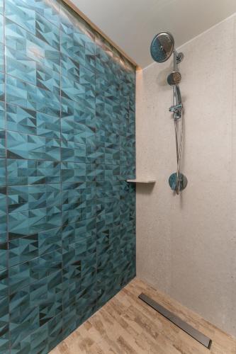 a bathroom with a shower with a glass wall at Condos Privados en Huatulco in Tangolunda