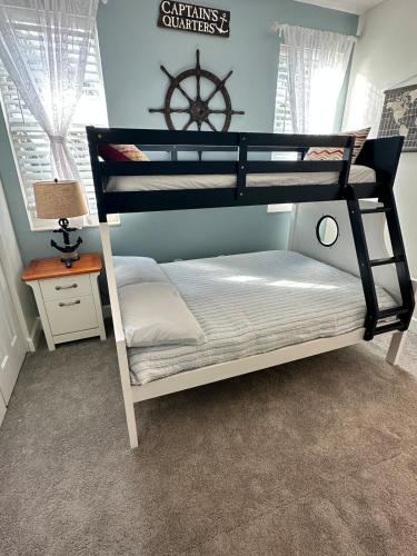 a bedroom with two bunk beds and a table at Spacious 3BR 3BA with King Bed & Amazing Pools near Intercoastal, Lantana Beach, FL in Lantana