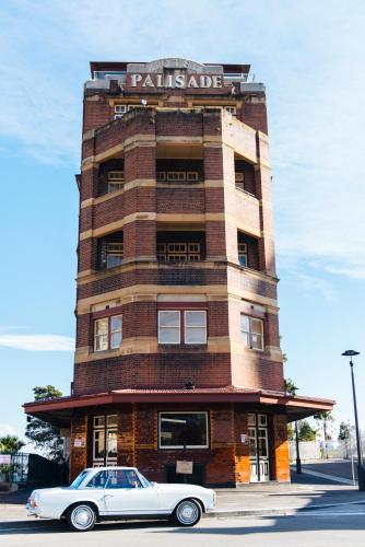 a white car parked in front of a building at Hotel Palisade in Sydney