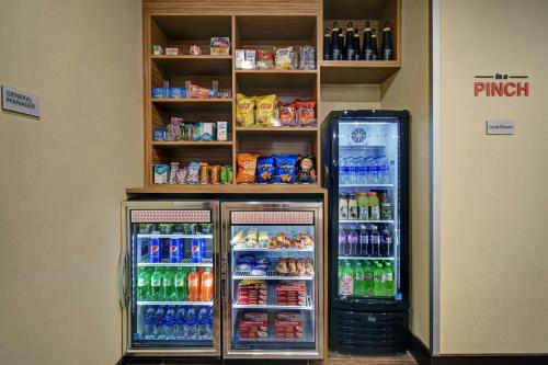 a refrigerator and a drink cooler in a store at TownePlace Suites by Marriott Grand Rapids Wyoming in Wyoming
