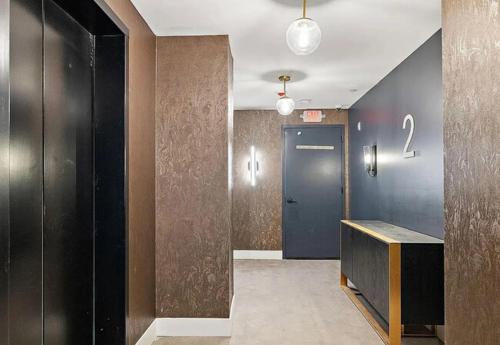 a hallway with a blue door and a number on the wall at Stunning 1bd1bth I New Construction in Wilmington