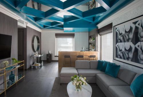 a living room with a couch and blue ceilings at Andaz San Diego, By Hyatt in San Diego