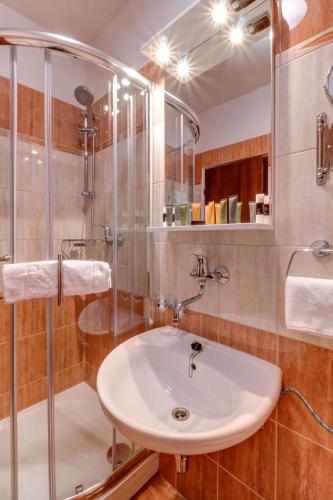 a bathroom with a sink and a shower at Best Western Hotel Vista in Ostrava