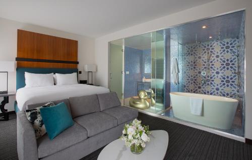 a hotel room with a bed and a couch at Andaz San Diego, By Hyatt in San Diego