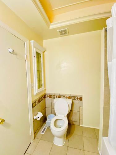 a bathroom with a toilet and a window at 1 bedroom terrace view with shared bathroom #4 in Laurel