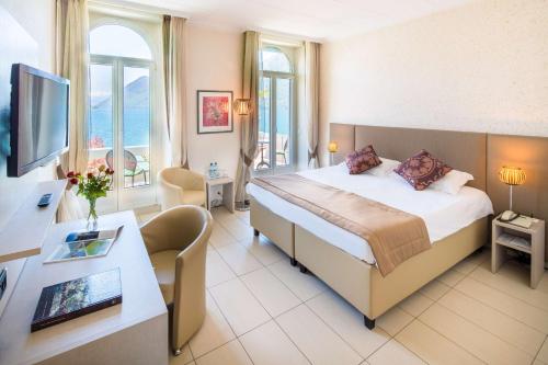 a hotel room with a bed and a desk at Best Western Hotel Bellevue au Lac in Lugano