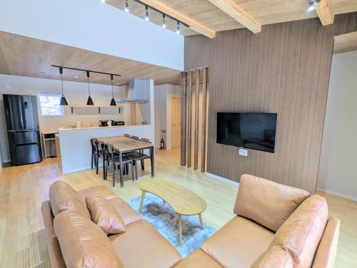 a living room with a couch and a table at Asuka Resort 富士山中湖 in Yamanakako
