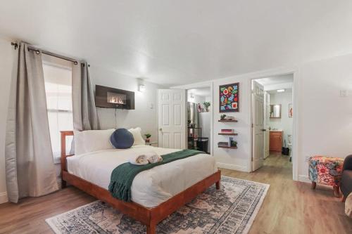 a bedroom with a bed with a dog laying on it at Homey Studio Near Downtown Sac and American River in Sacramento