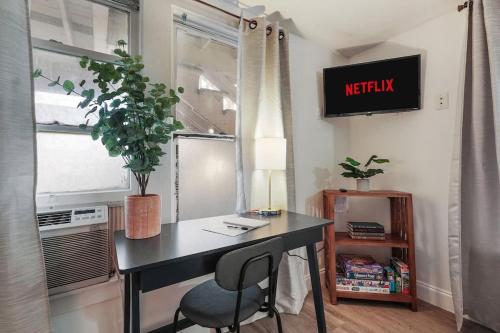 a desk with a chair in a room with a window at Homey Studio Near Downtown Sac and American River in Sacramento