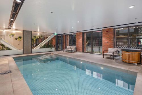 a swimming pool in the middle of a building at The Courtenay Chic Retreat 1BR Apartment in Wellington