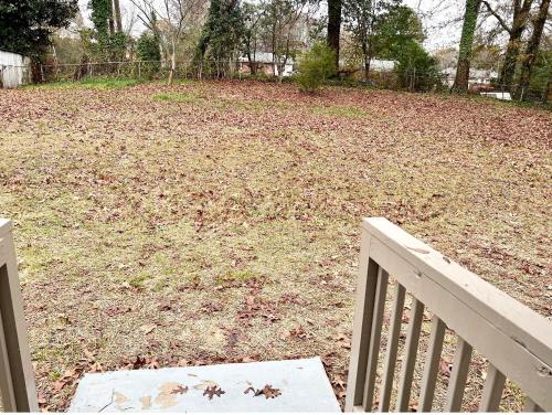 a park with a white fence and a field of leaves at Queen Suite - Attached Bath - Home Theater - Home Tub in Forest Park