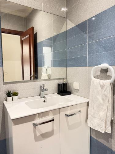 a bathroom with a sink and a mirror at SUITOUISS - AGDAL 5 - Appartements à 2 minutes de la gare de train TGV Rabat in Rabat