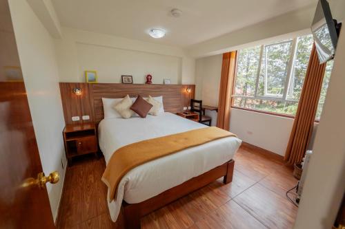 a bedroom with a large bed and a window at Dreams Boutique Hotel Cusco in Cusco