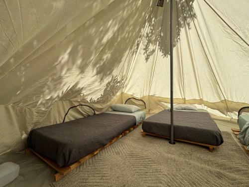 Postel nebo postele na pokoji v ubytování Glamping El Arbol - Naturaleza y Mar