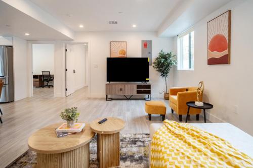 a living room with a flat screen tv at Cozy Urban Retreat near Downtown LA & USC - Private room with shared Living room and kitchen in Los Angeles