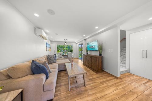 a living room with a couch and a table at 2 Min Walk To Eagle Beach W Pool, Gym & Spa in Palm-Eagle Beach