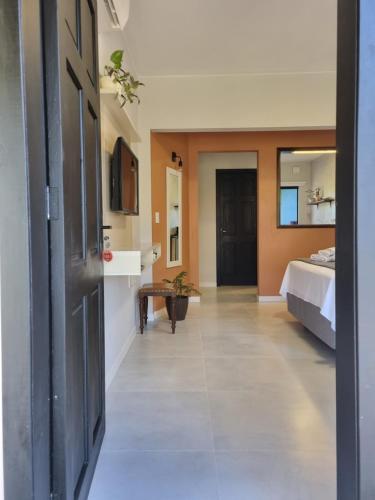 a room with a bedroom and a bed and a hallway at Frieden Haus Hospedagem in Pomerode