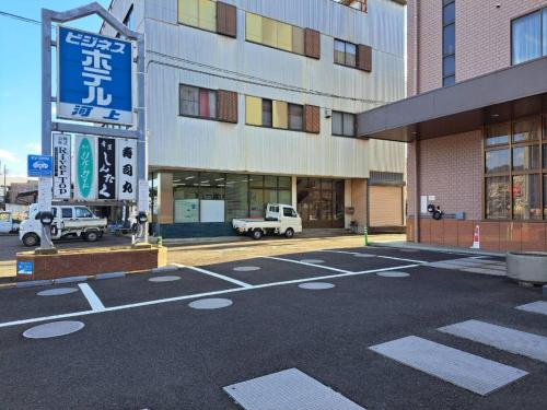 an empty parking lot in front of a building at Business Hotel Kawakami in Kumano